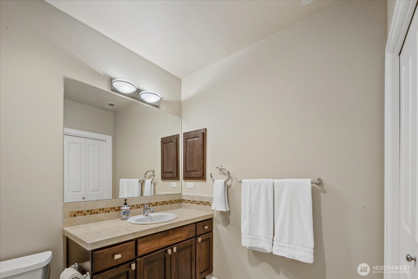 215 Ilwaco Place Southeast Renton, WA 98059 - Photo 34 of 40 a bathroom with a sink and a mirror