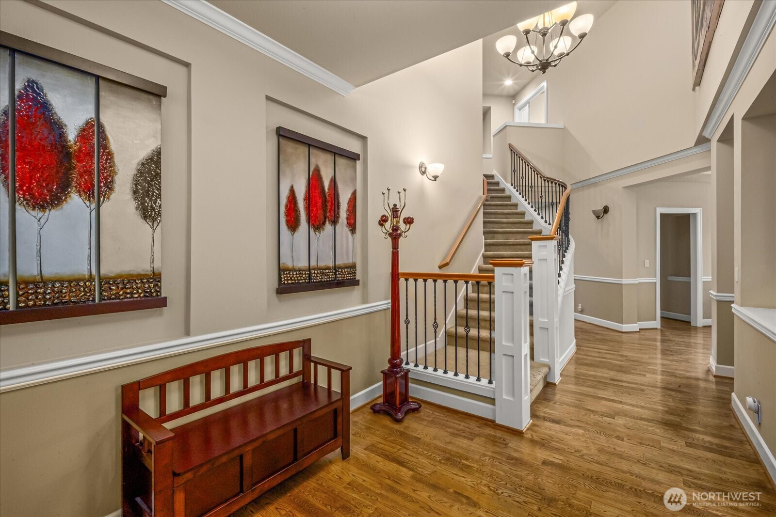 215 Ilwaco Place Southeast Renton, WA 98059 - Photo 5 of 40 a view of staircase with lots of frames on wall and wooden floor