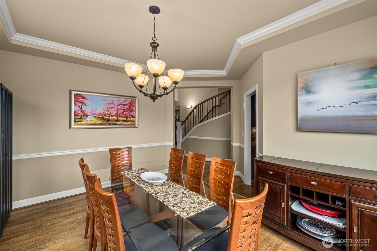 215 Ilwaco Place Southeast Renton, WA 98059 - Photo 10 of 40 a dining room with wooden floor a chandelier a wooden table and chairs