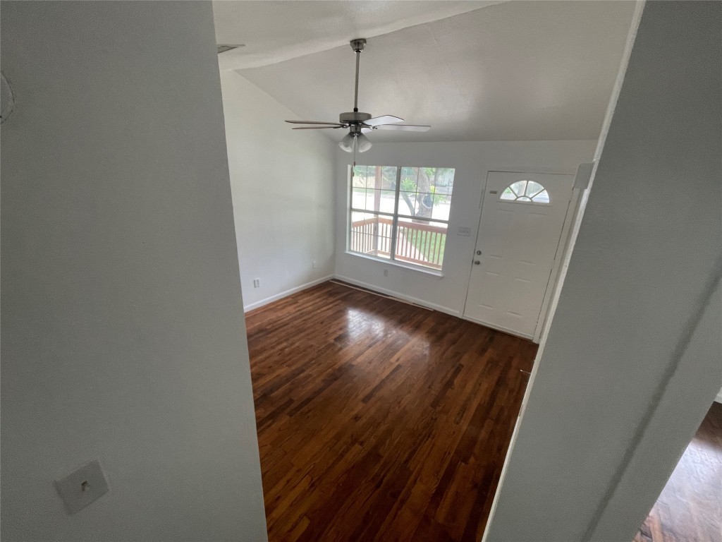 2808 Lyons Road, Unit A Austin, TX 78702 - Photo 11 of 13 an empty room with wooden floor chandelier and windows