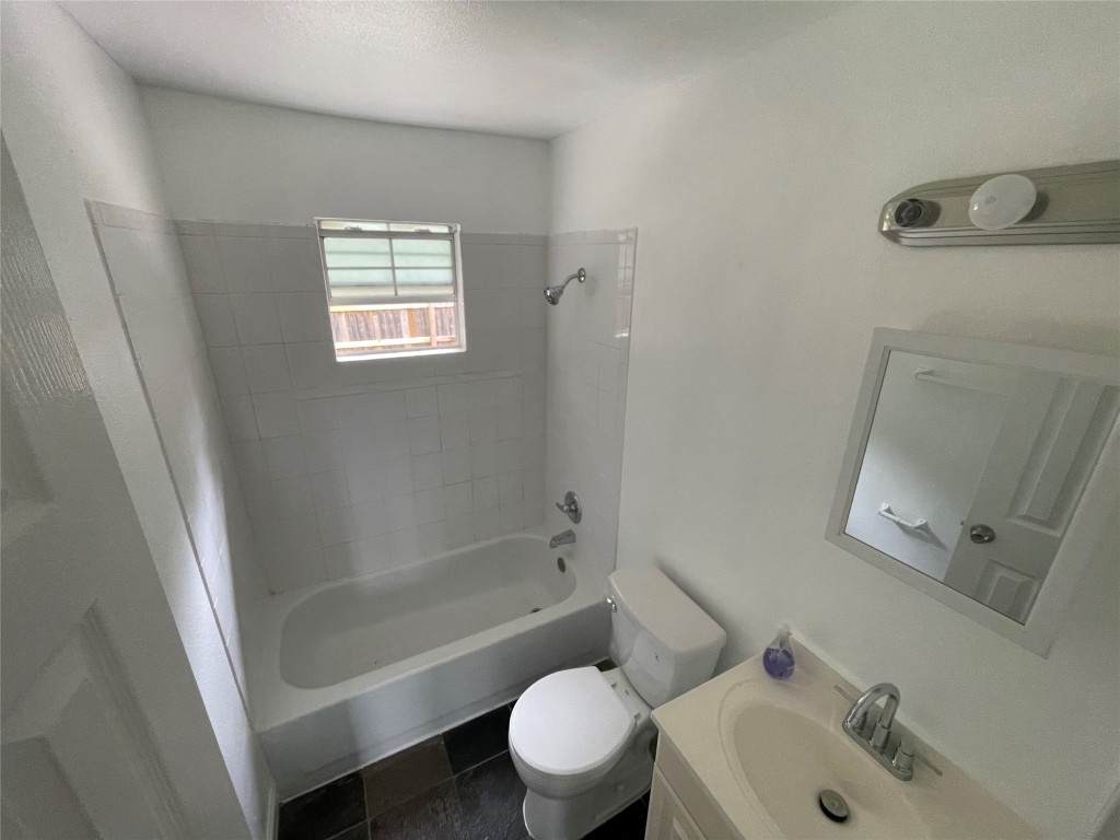 2808 Lyons Road, Unit A Austin, TX 78702 - Photo 12 of 13 a bathroom with a sink toilet and shower
