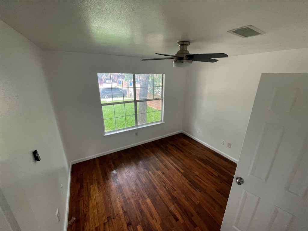 2808 Lyons Road, Unit A Austin, TX 78702 - Photo 10 of 13 a view of an empty room with wooden floor and a window