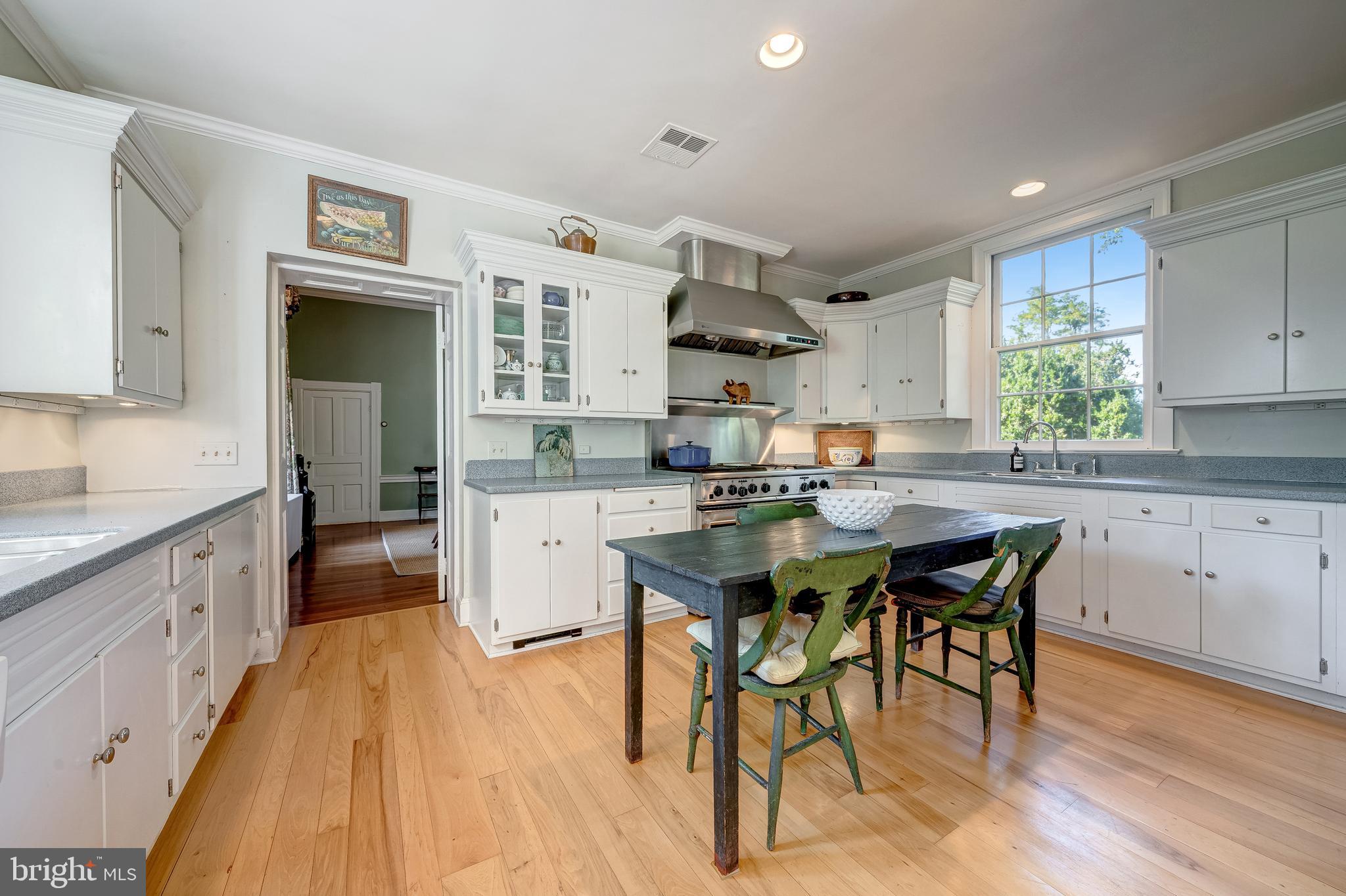 3707 Carrington Road Delaplane, VA 20144 - Photo 25 of 52 a kitchen with a table chairs stove and cabinets