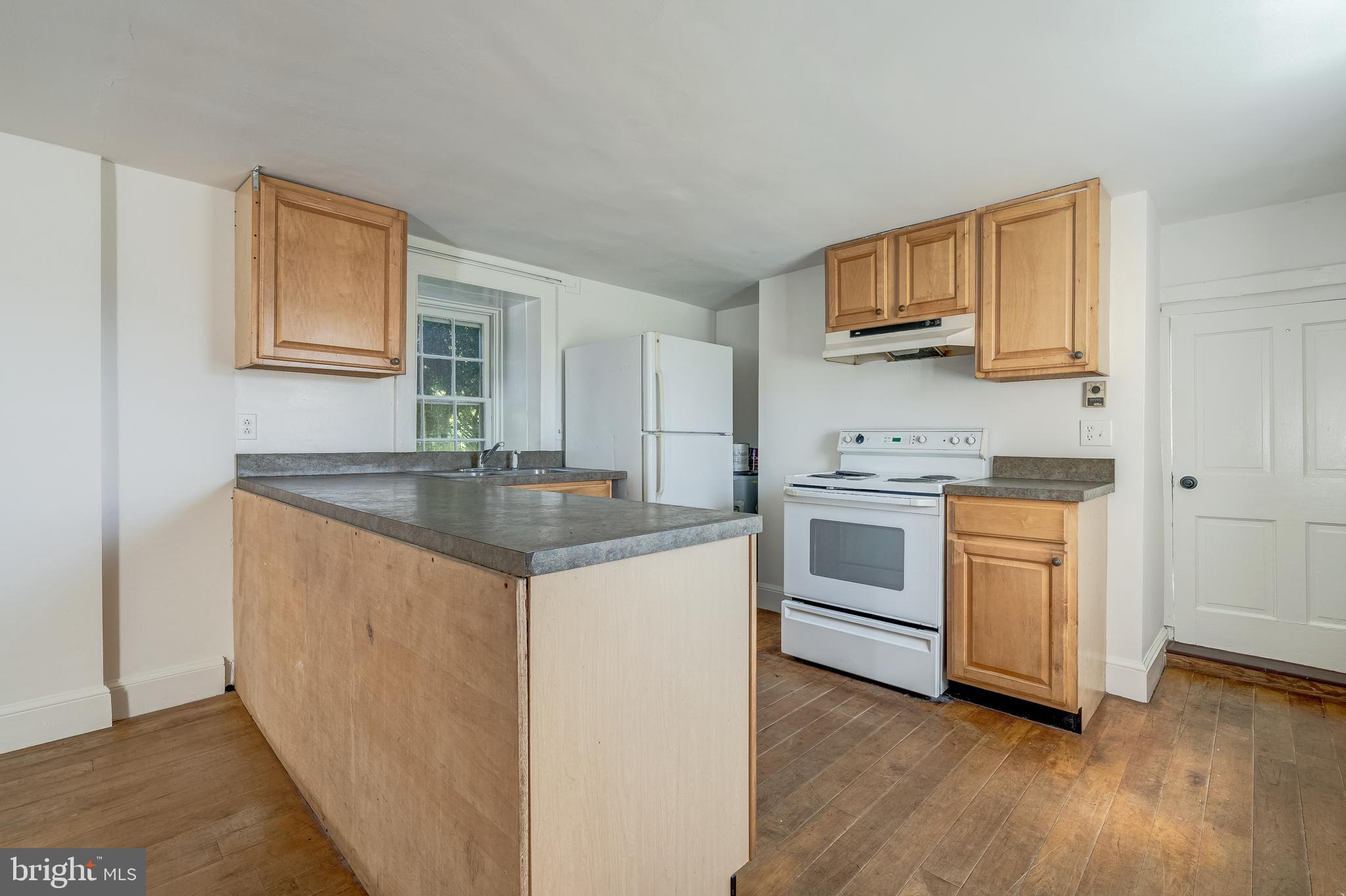 3707 Carrington Road Delaplane, VA 20144 - Photo 42 of 52 a kitchen with stainless steel appliances granite countertop a sink stove and wooden floor