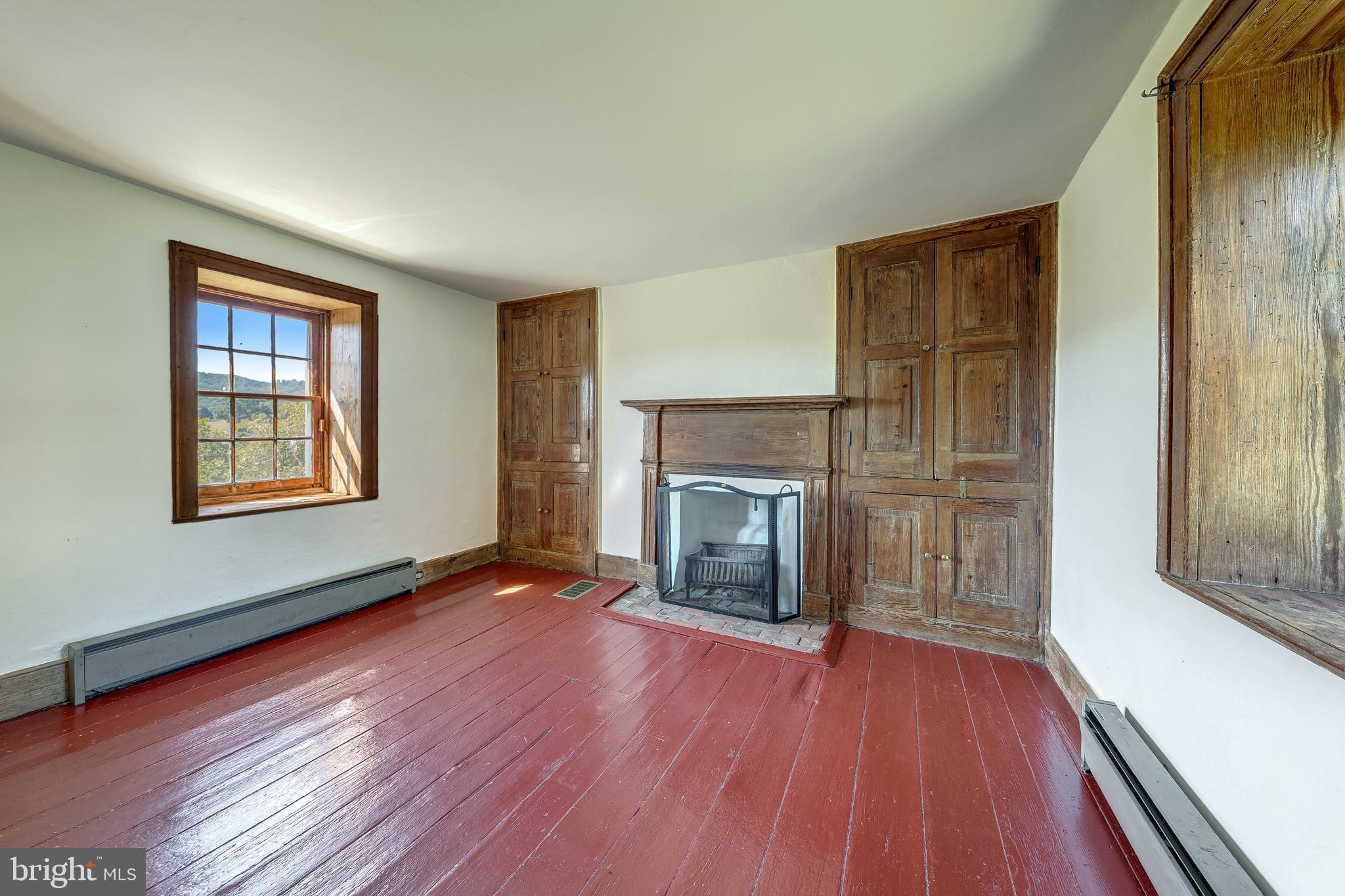 3707 Carrington Road Delaplane, VA 20144 - Photo 43 of 52 wooden floor fireplace and windows in an empty room