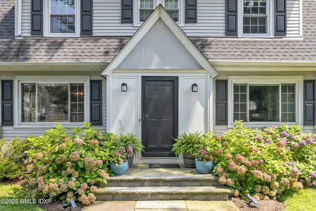 a view of a house with potted plants