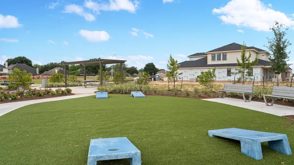a view of a terrace with a garden and outdoor seating
