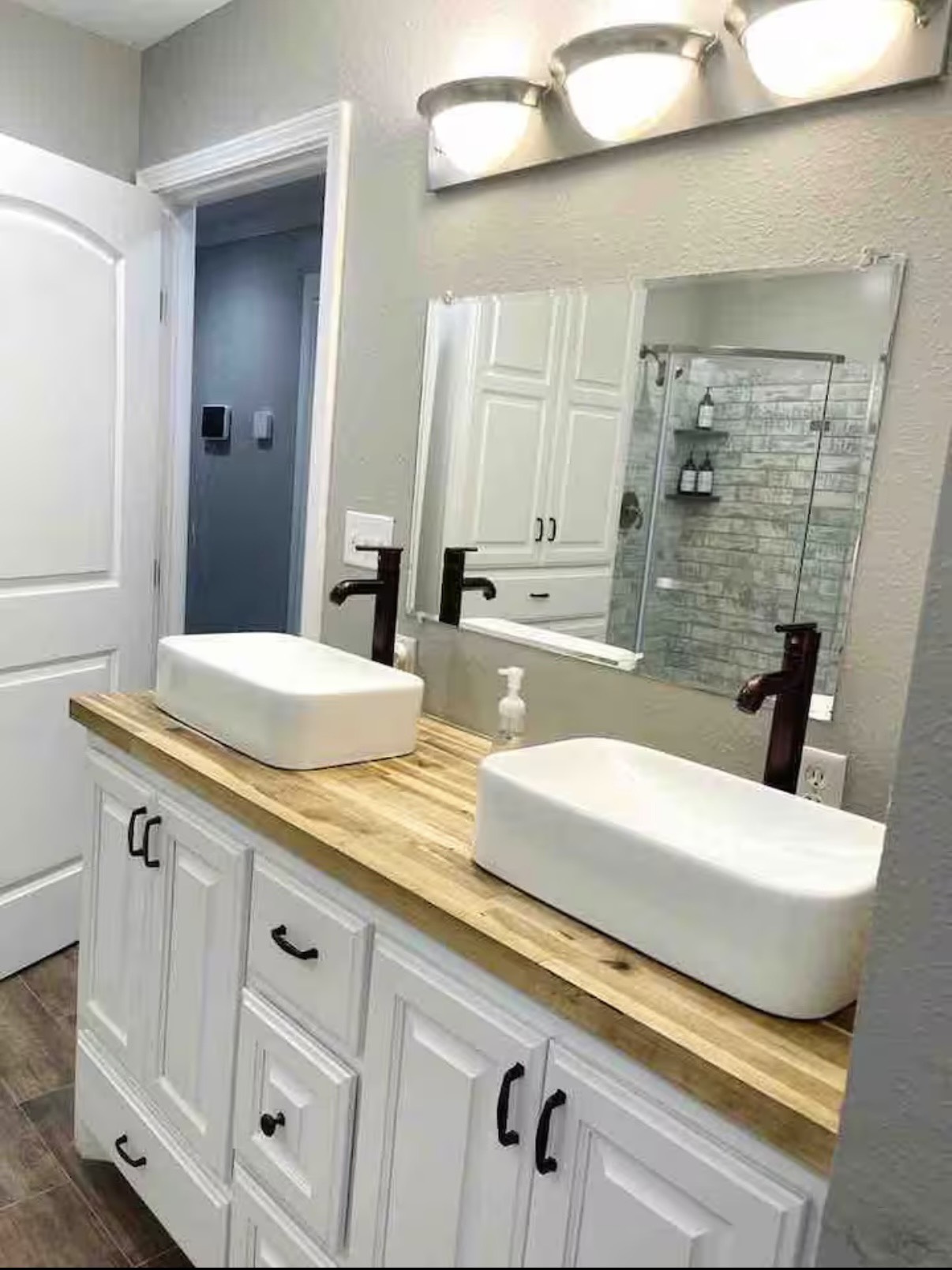 3103 Monroe Street Nederland, TX 77627 - Photo 6 of 11 a bathroom with a double vanity sink and mirror