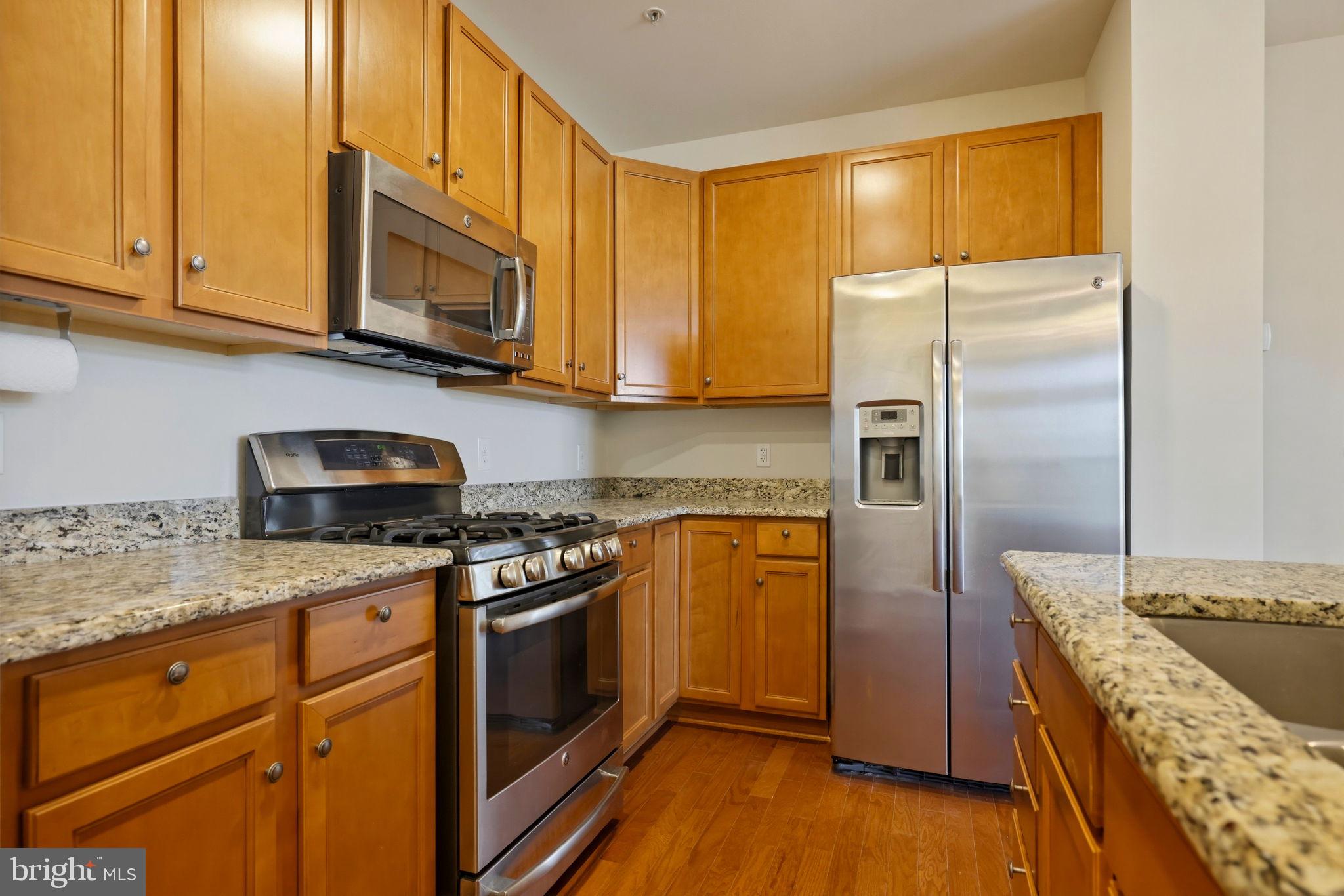 43487 Town Gate Square Chantilly, VA 20152 - Photo 11 of 56 a kitchen with stainless steel appliances granite countertop a stove a refrigerator and a microwave