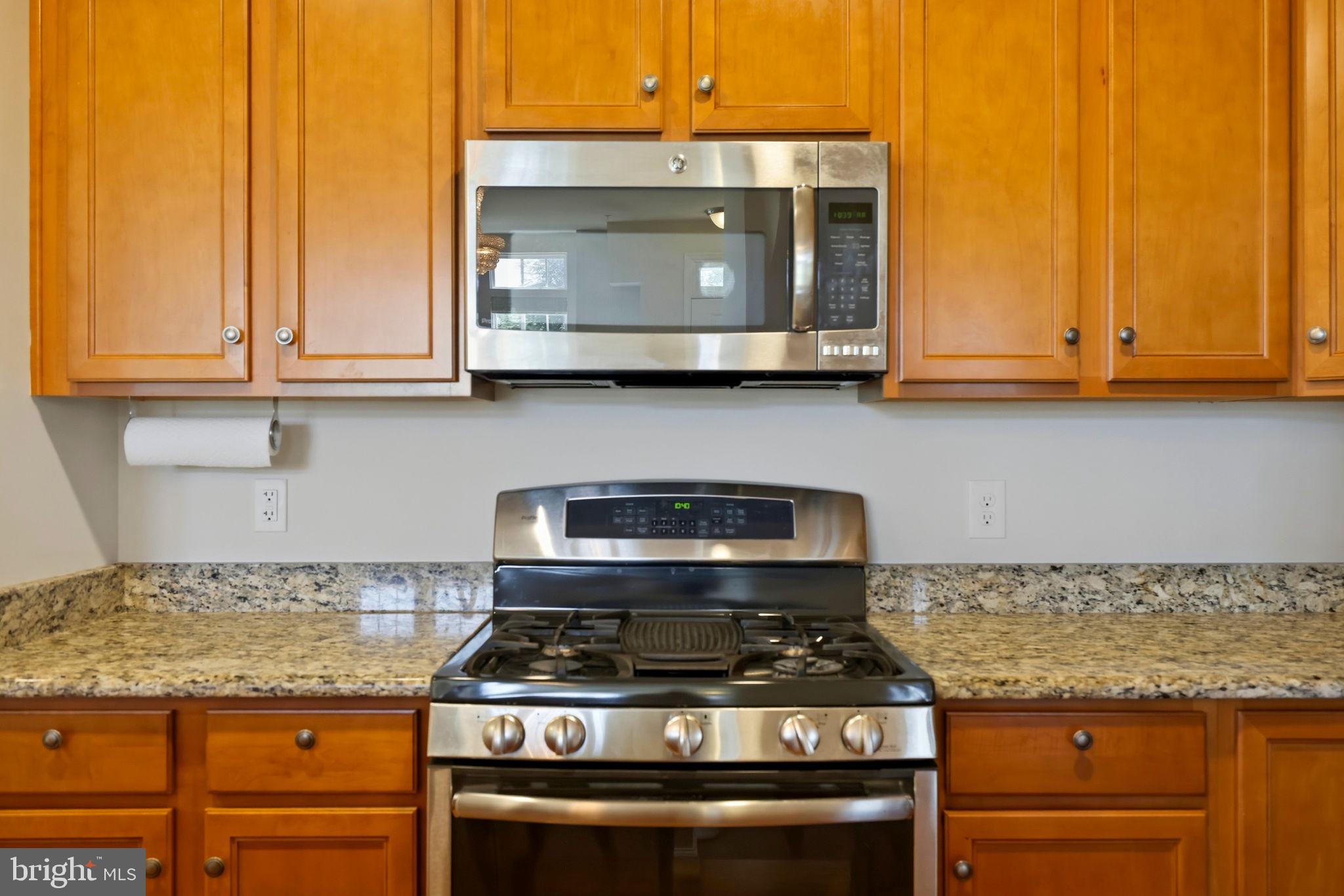 43487 Town Gate Square Chantilly, VA 20152 - Photo 12 of 56 a kitchen with granite countertop a stove and a microwave