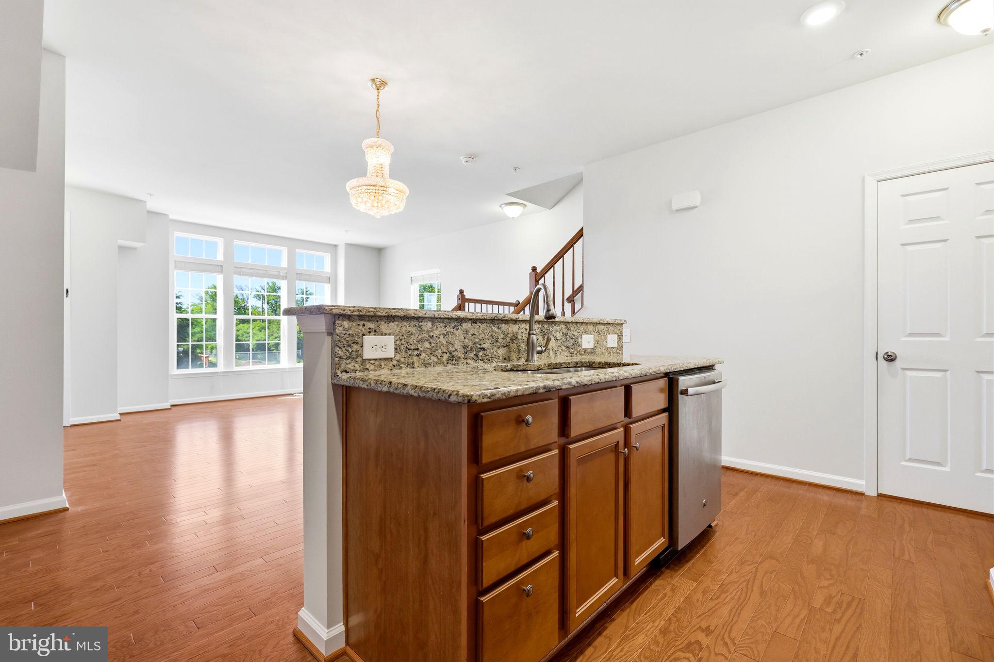 43487 Town Gate Square Chantilly, VA 20152 - Photo 14 of 56 a kitchen with a sink cabinets and wooden floor