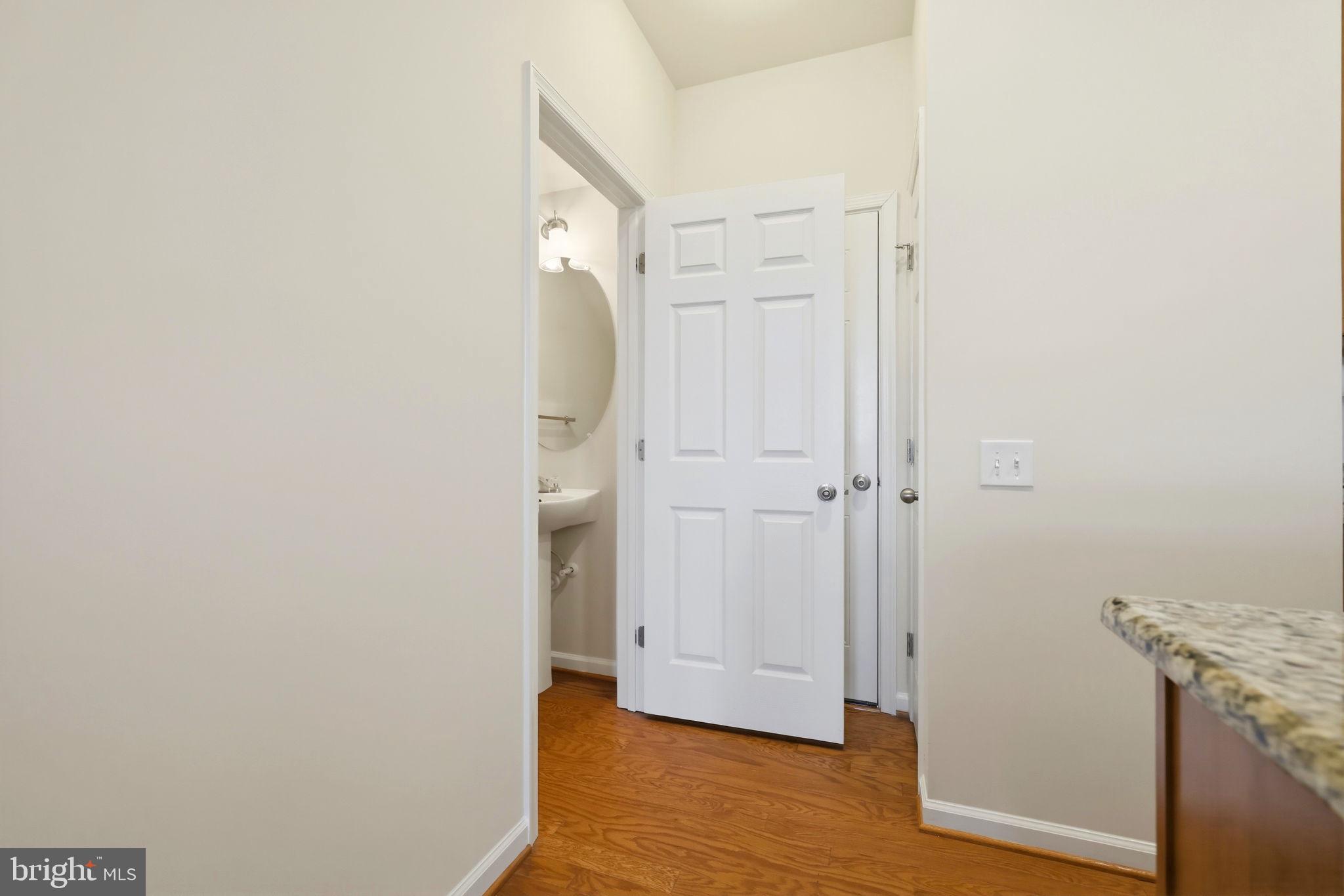 43487 Town Gate Square Chantilly, VA 20152 - Photo 17 of 56 a view of a hallway with wooden floor