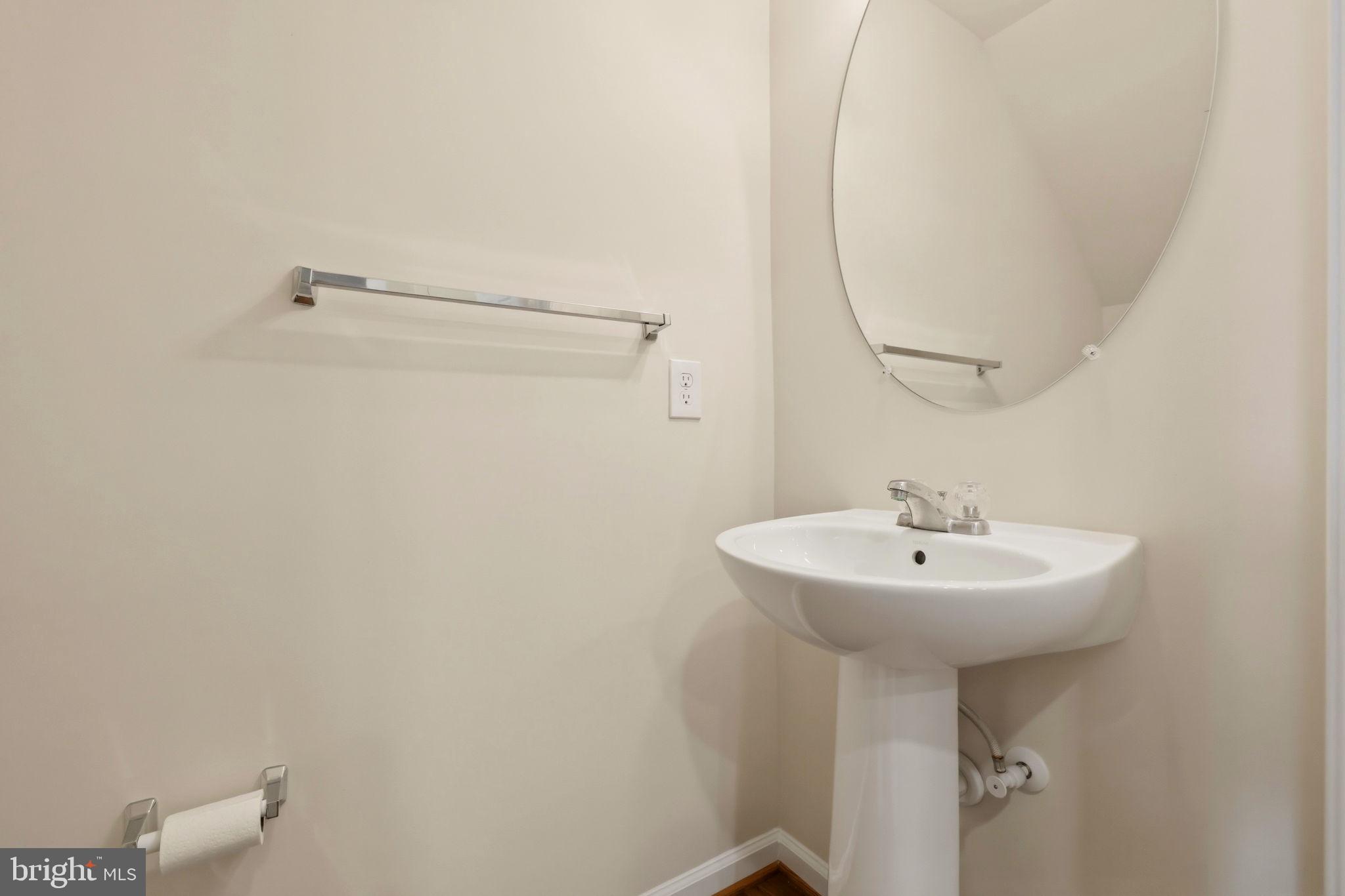 43487 Town Gate Square Chantilly, VA 20152 - Photo 18 of 56 a bathroom with a sink a mirror and a shower