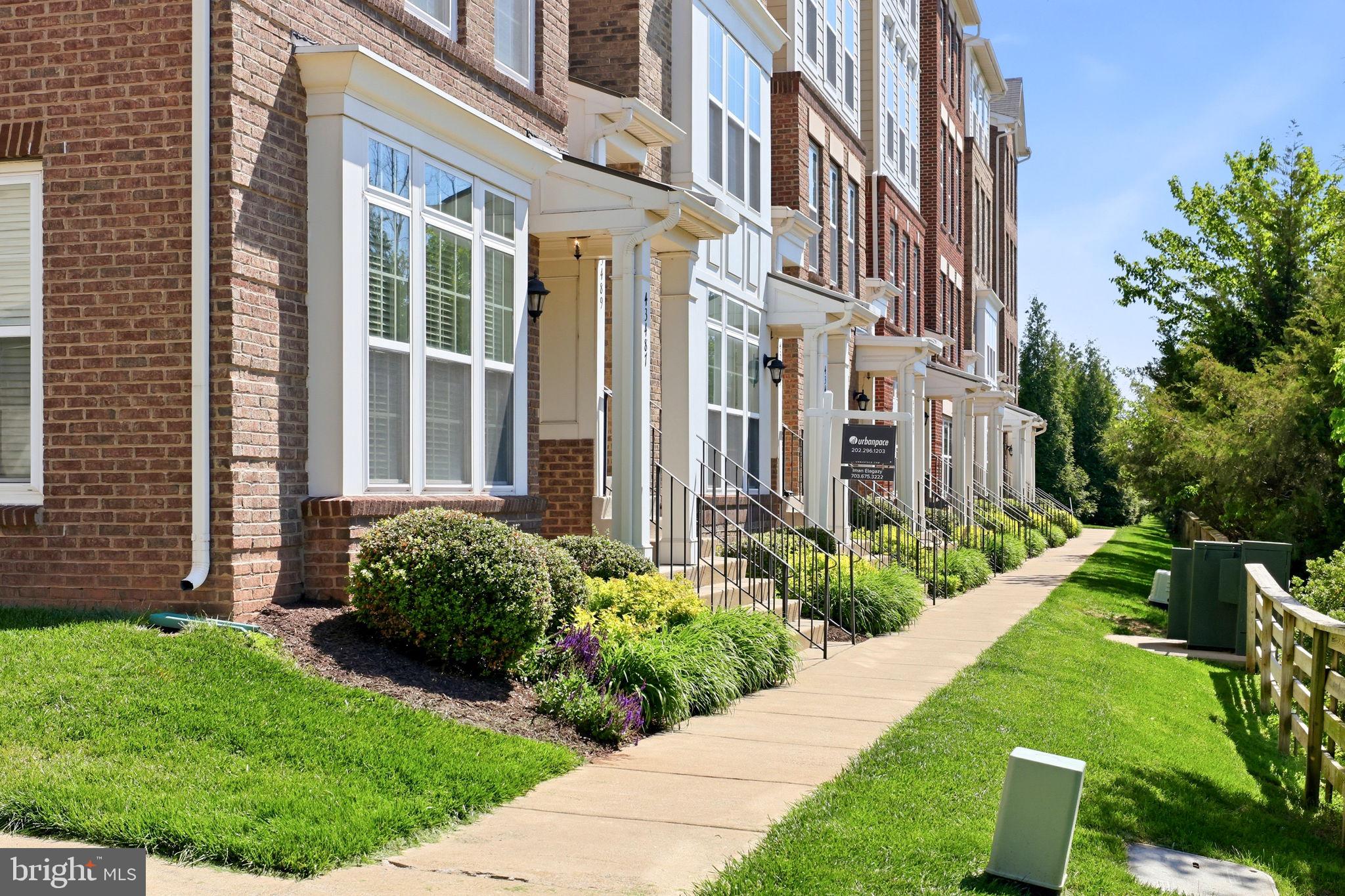 43487 Town Gate Square Chantilly, VA 20152 - Photo 2 of 56 a view of a building with garden and pathway