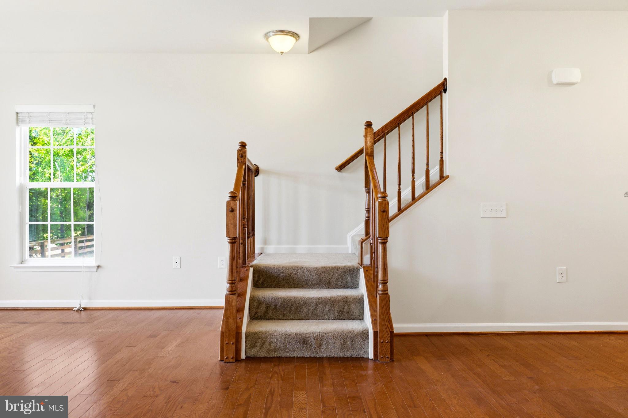 43487 Town Gate Square Chantilly, VA 20152 - Photo 23 of 56 a view of entryway with wooden floor and stairs