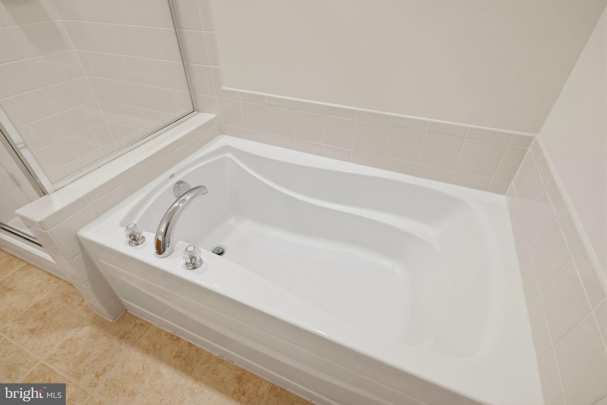 43487 Town Gate Square Chantilly, VA 20152 - Photo 31 of 56 a bathroom with a bathtub