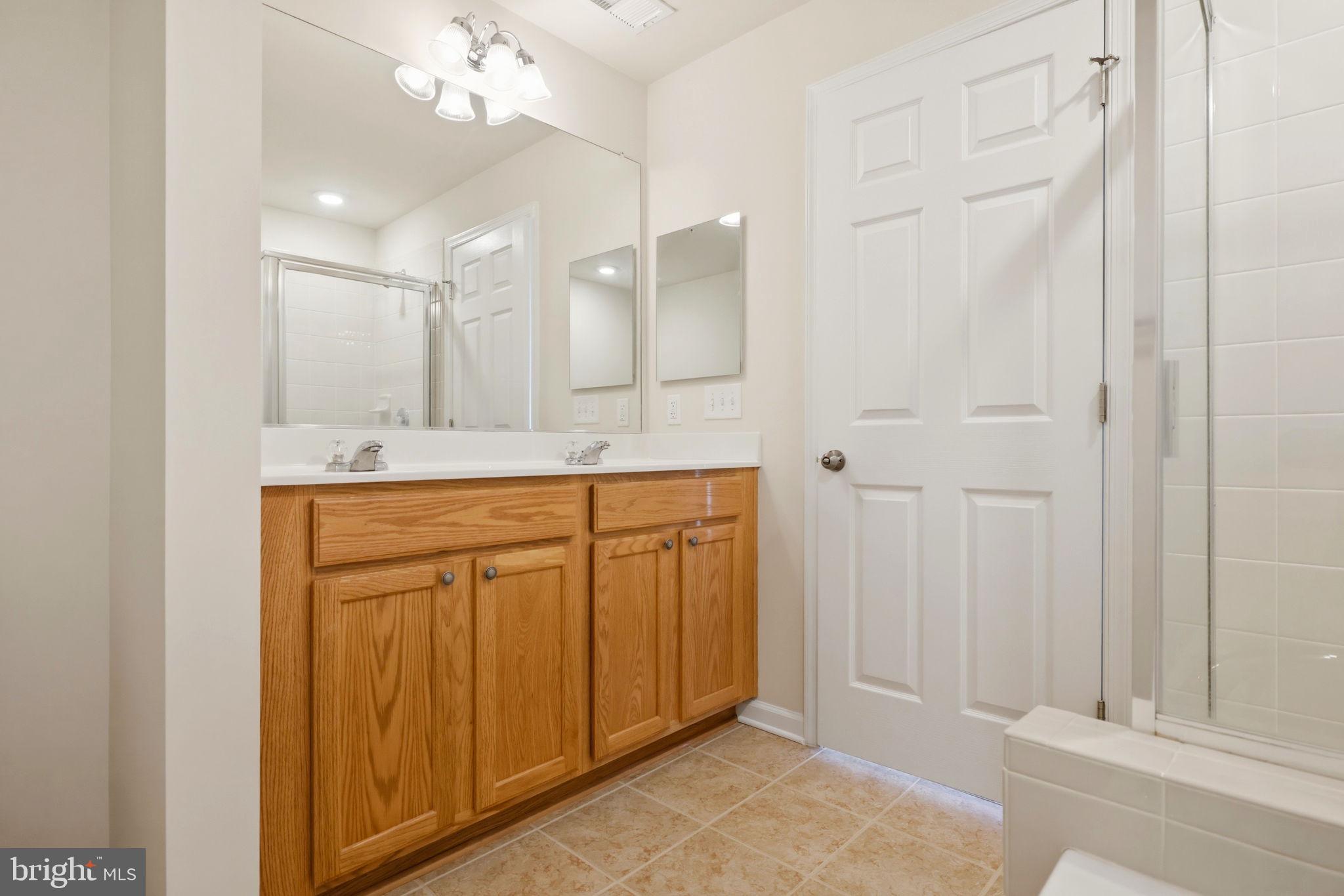 43487 Town Gate Square Chantilly, VA 20152 - Photo 33 of 56 a bathroom with a sink and a mirror