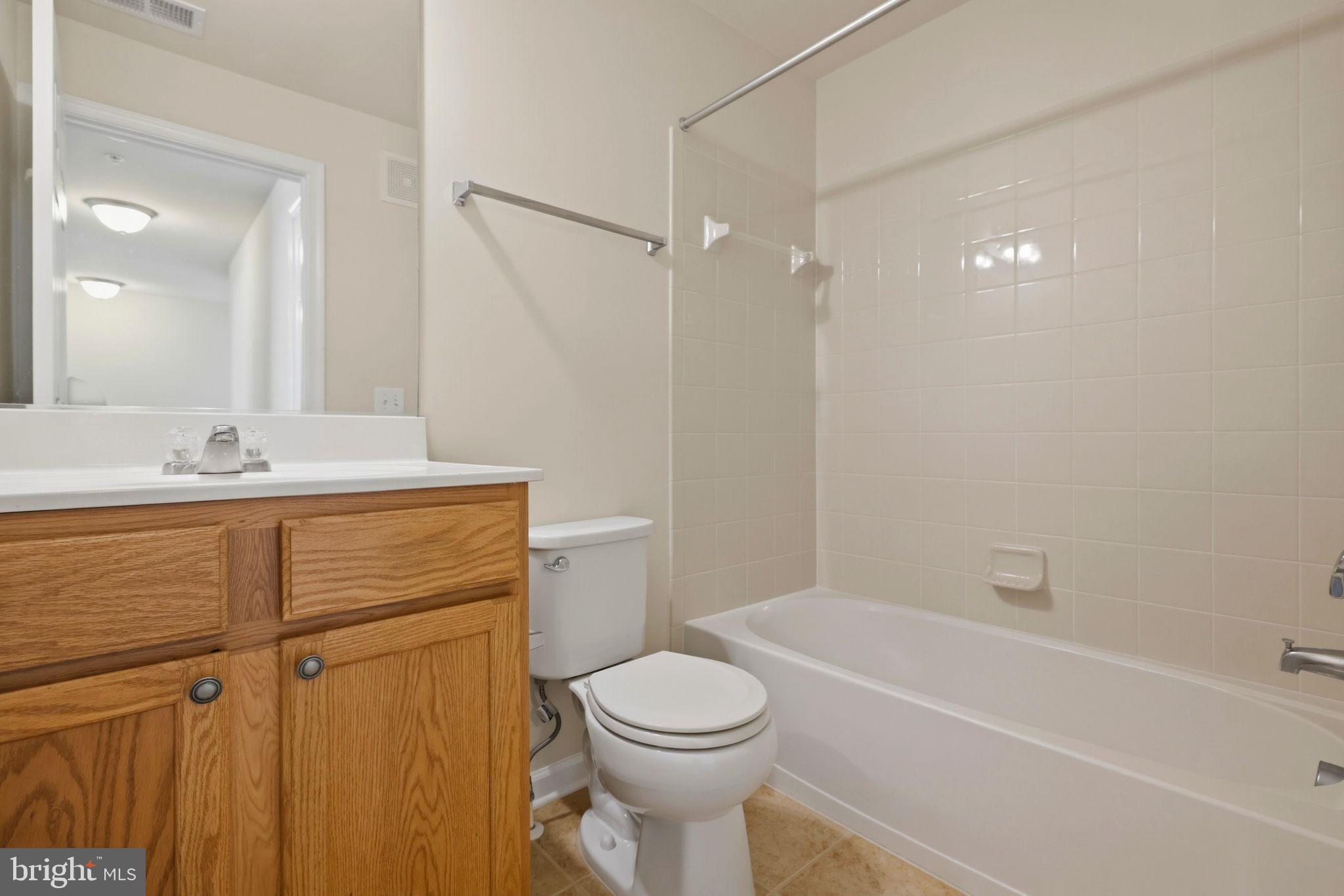 43487 Town Gate Square Chantilly, VA 20152 - Photo 37 of 56 a bathroom with a sink a toilet and shower