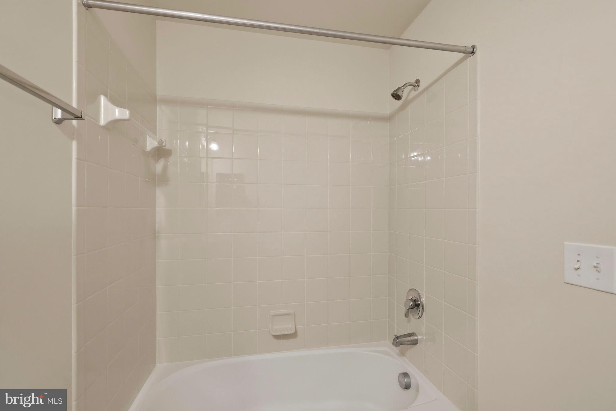 43487 Town Gate Square Chantilly, VA 20152 - Photo 38 of 56 a bathroom with a bathtub and a shower
