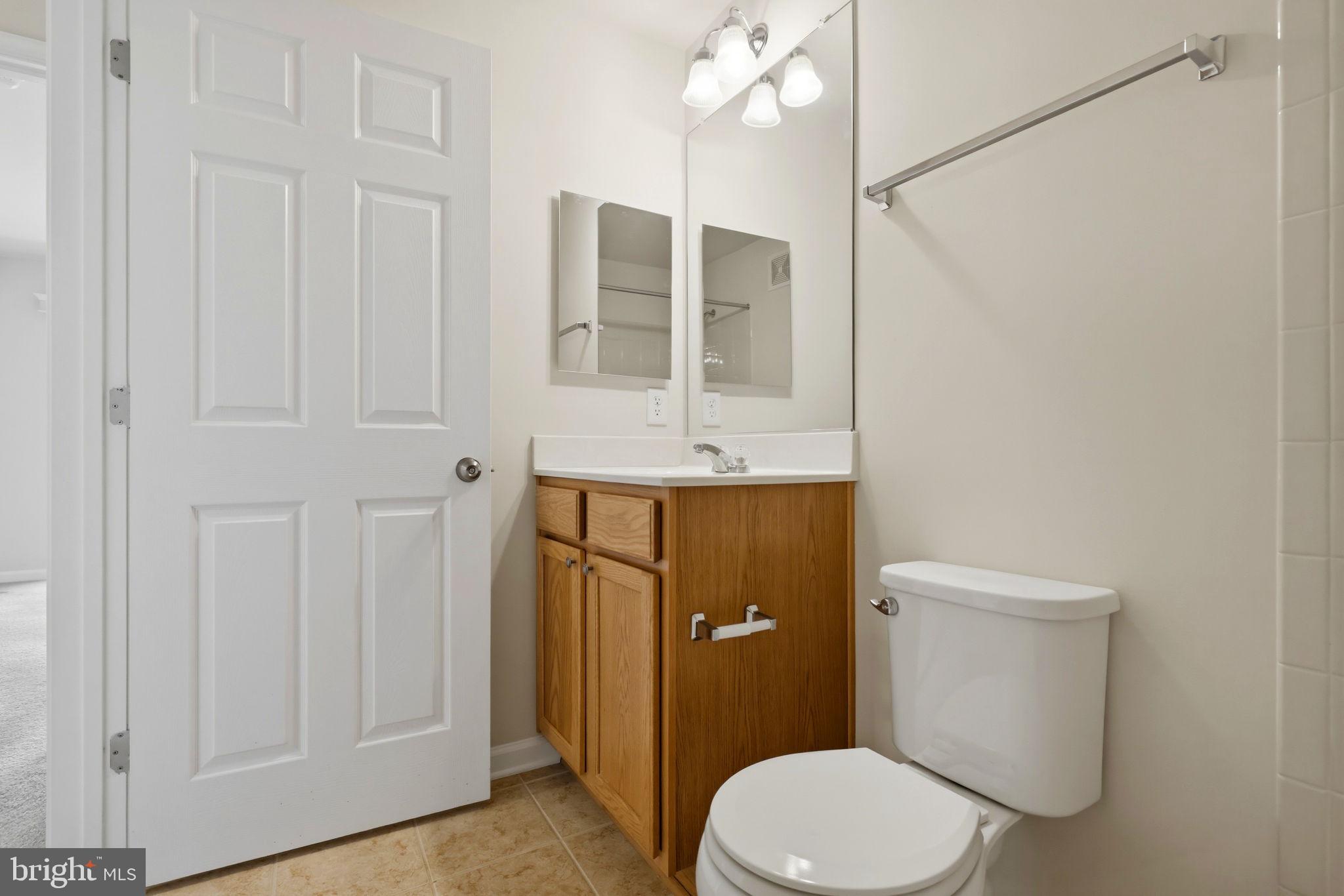 43487 Town Gate Square Chantilly, VA 20152 - Photo 39 of 56 a bathroom with a sink a toilet a mirror and shower