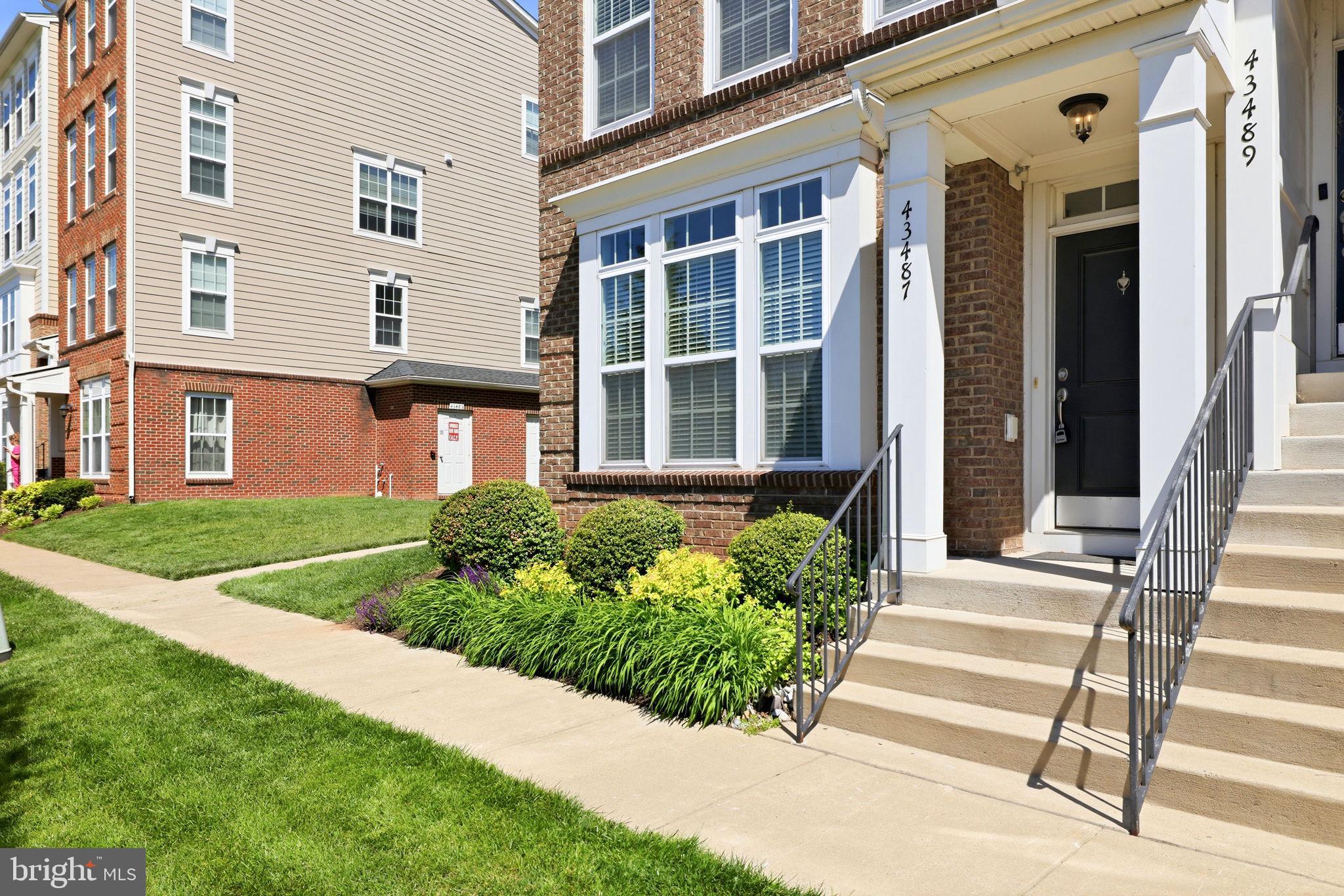 43487 Town Gate Square Chantilly, VA 20152 - Photo 4 of 56 a front view of a house with a yard