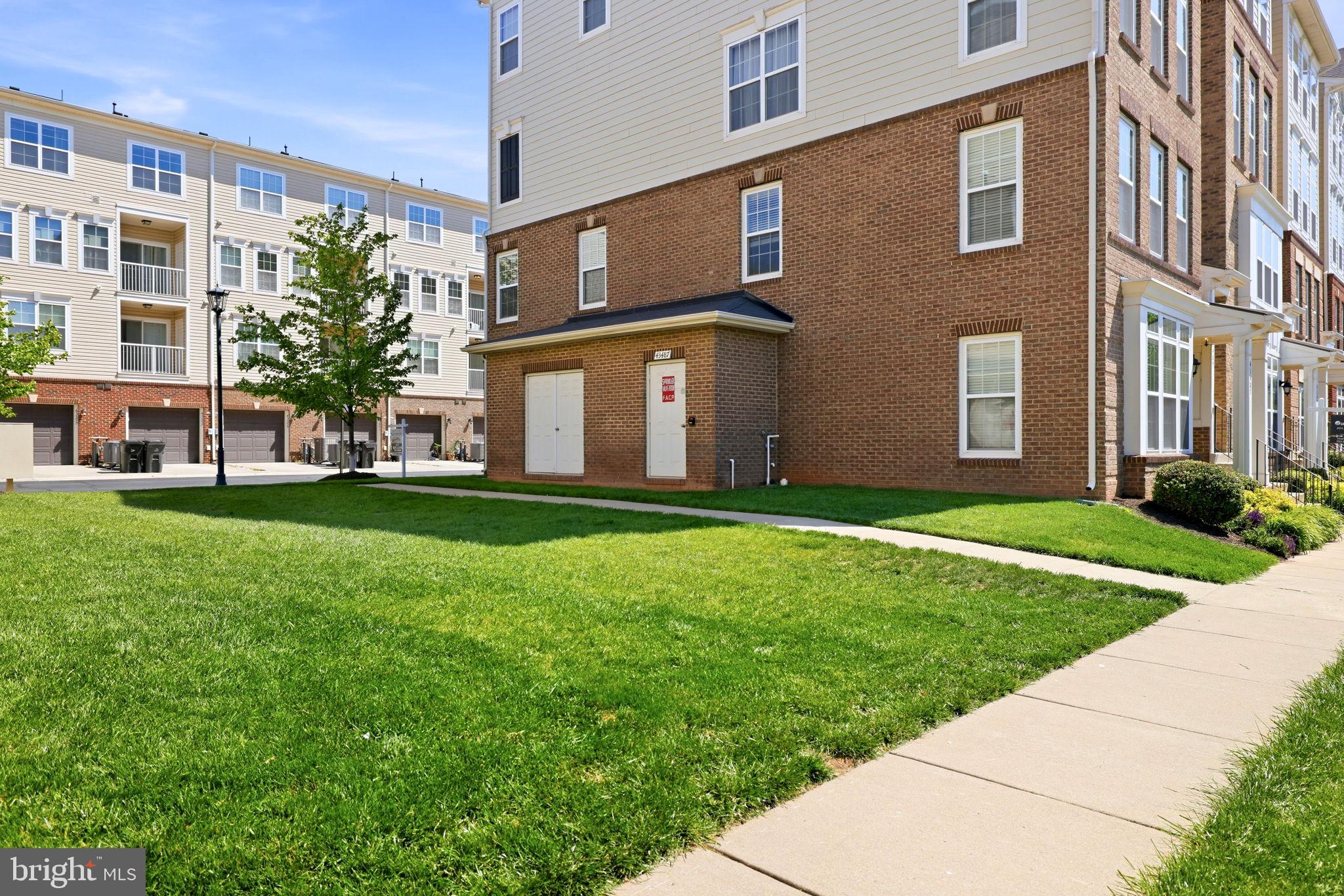 43487 Town Gate Square Chantilly, VA 20152 - Photo 49 of 56 a view of a building next to a big yard