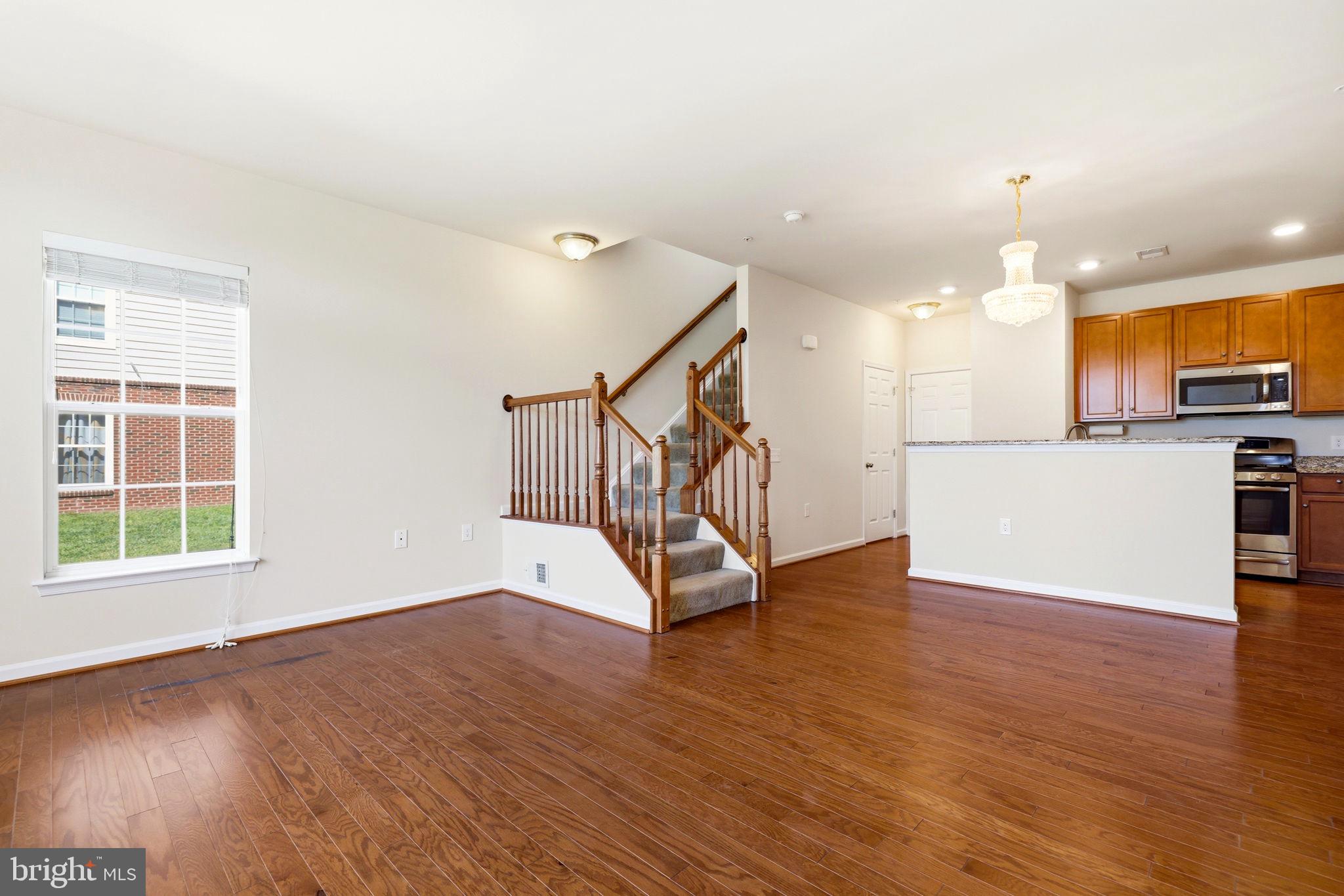 43487 Town Gate Square Chantilly, VA 20152 - Photo 8 of 56 a view of an empty room with wooden floor and a window