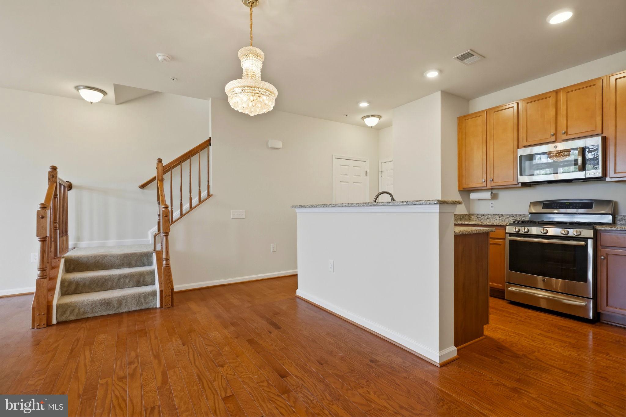43487 Town Gate Square Chantilly, VA 20152 - Photo 10 of 56 a view of kitchen with stove microwave and cabinets