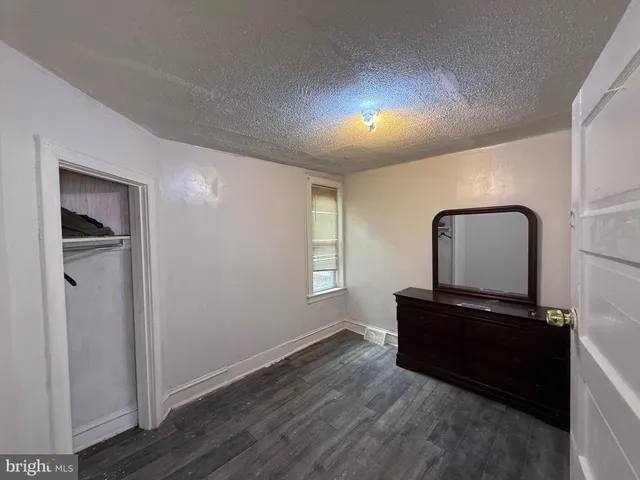 a view of a livingroom with wooden floor and windows