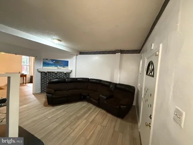 a living room with a couch and a fireplace