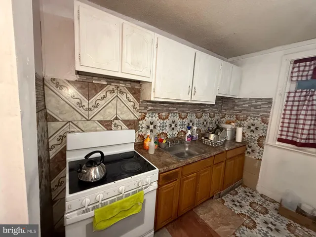 a kitchen with stainless steel appliances granite countertop a stove and a sink