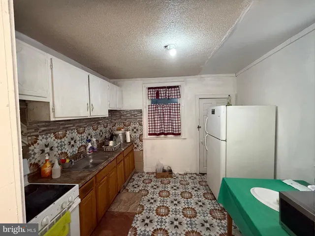 a kitchen with a sink stove and refrigerator