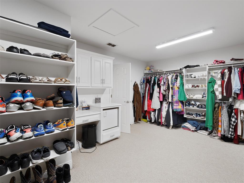 1103 Marigold Lane Longview, TX 75604 - Photo 24 of 34 a view of walk in closet with clothes and shoes