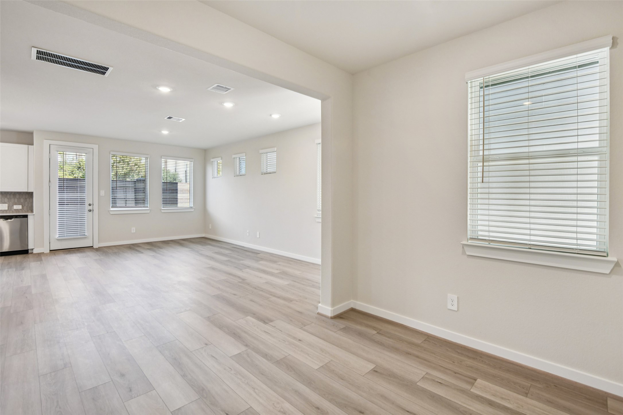10012 Rustic Charm Street Houston, TX 77080 - Photo 13 of 45 an empty room with wooden floor and windows