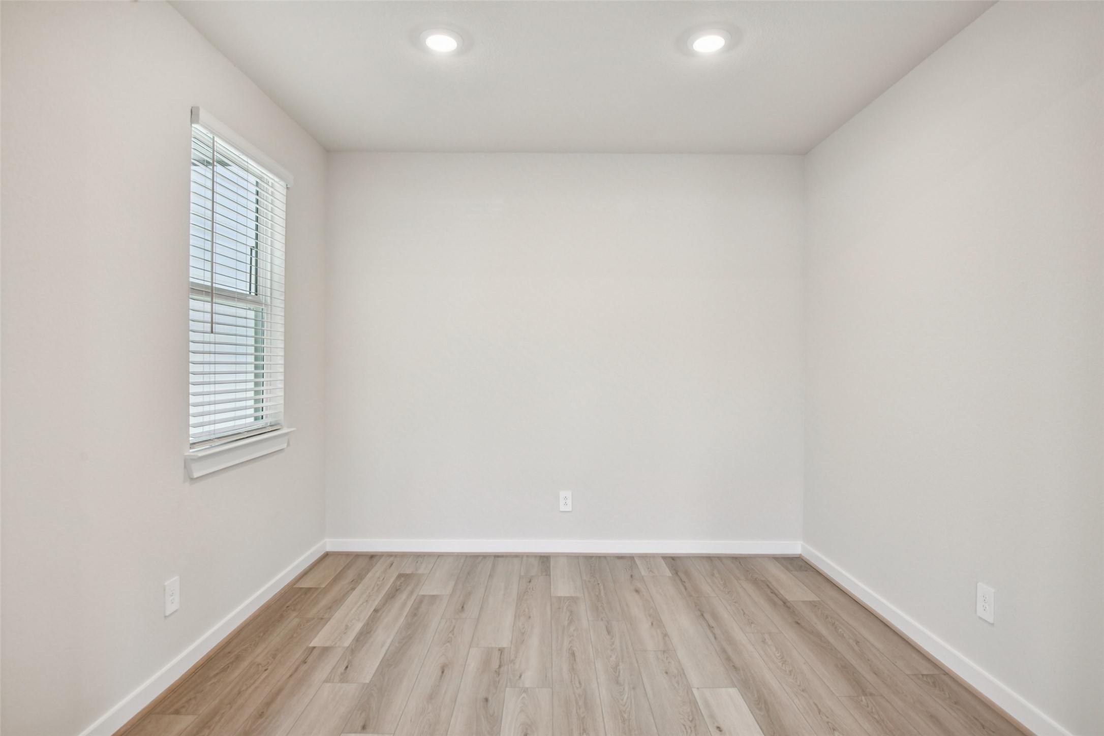 10012 Rustic Charm Street Houston, TX 77080 - Photo 14 of 45 a view of an empty room with wooden floor and a window