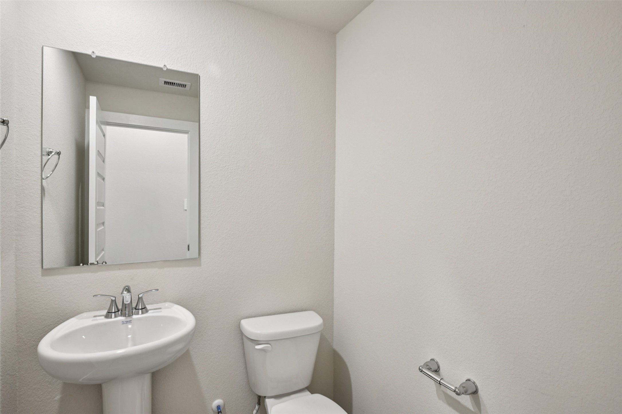 10012 Rustic Charm Street Houston, TX 77080 - Photo 17 of 45 a bathroom with a toilet sink and mirror