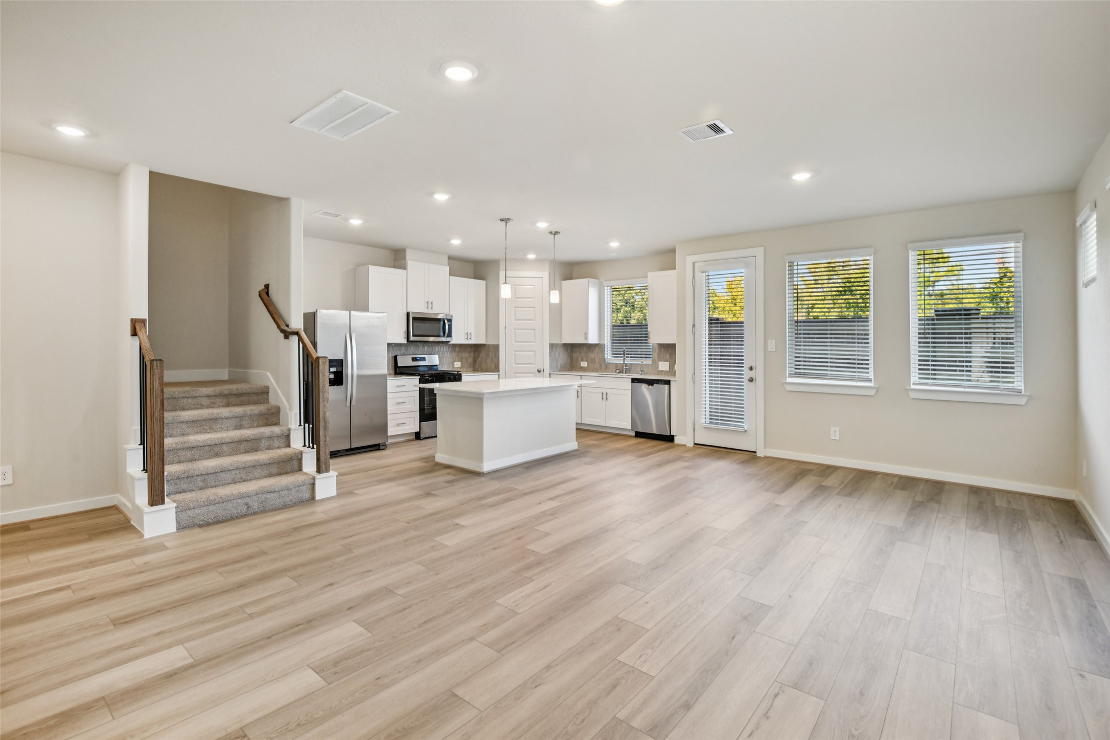 10012 Rustic Charm Street Houston, TX 77080 - Photo 6 of 45 a view of a kitchen with wooden floor and electronic appliances