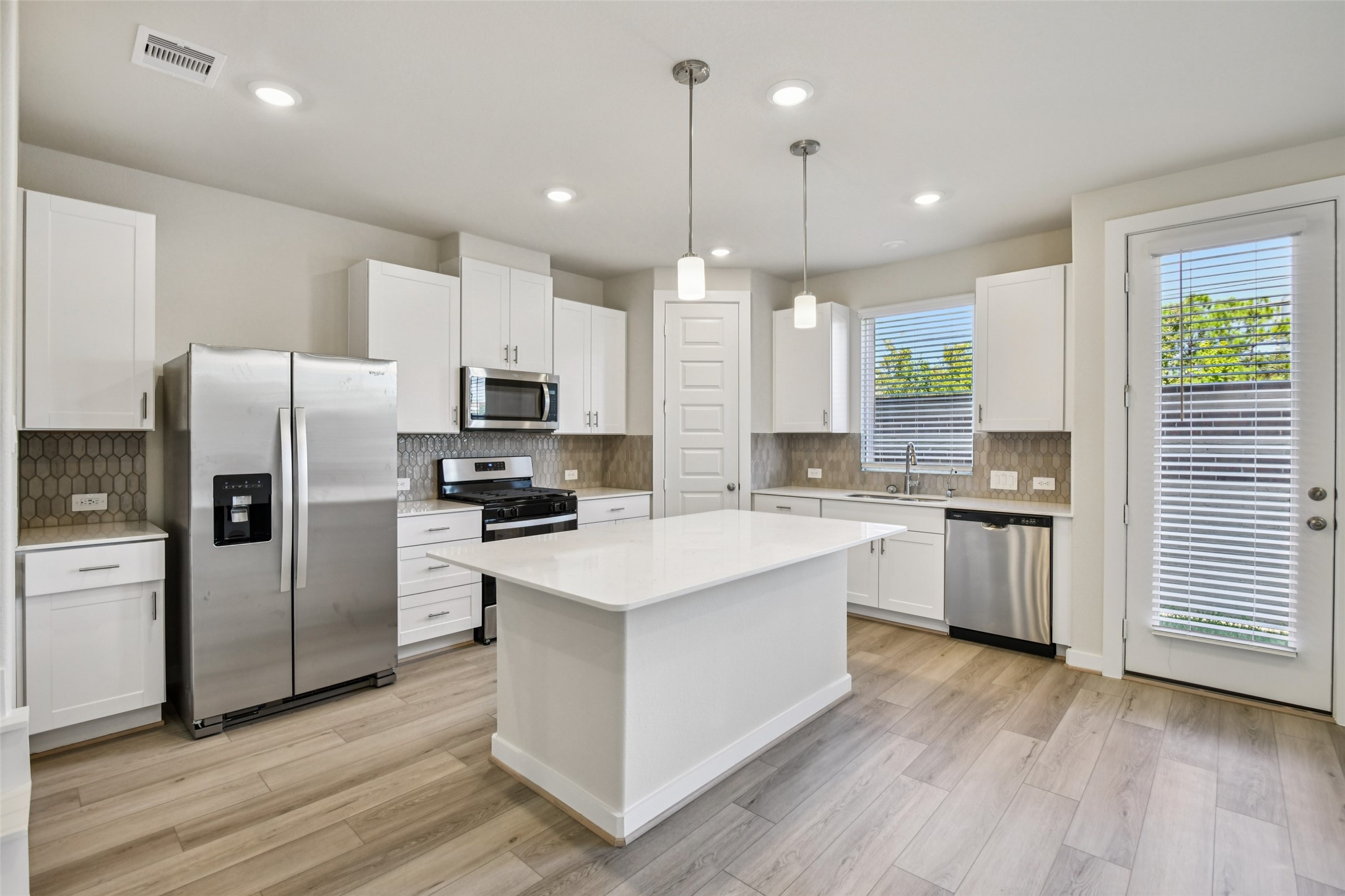 10012 Rustic Charm Street Houston, TX 77080 - Photo 9 of 45 a kitchen with a refrigerator a sink and wooden floor