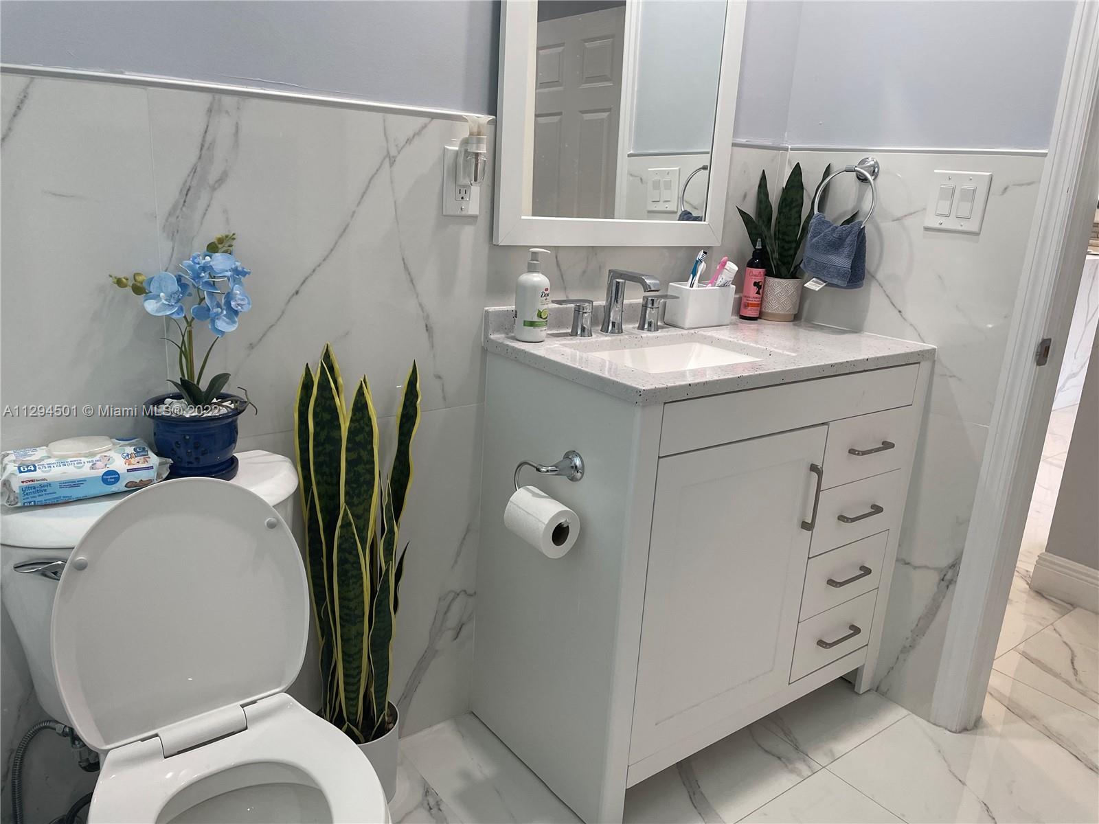 2222 Southwest 138th Avenue Miami, FL 33175 - Photo 11 of 27 a bathroom with a granite countertop sink a toilet and with mirror
