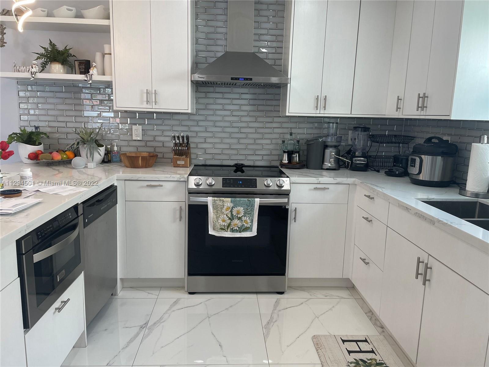 2222 Southwest 138th Avenue Miami, FL 33175 - Photo 12 of 27 a kitchen with a stove sink and cabinets