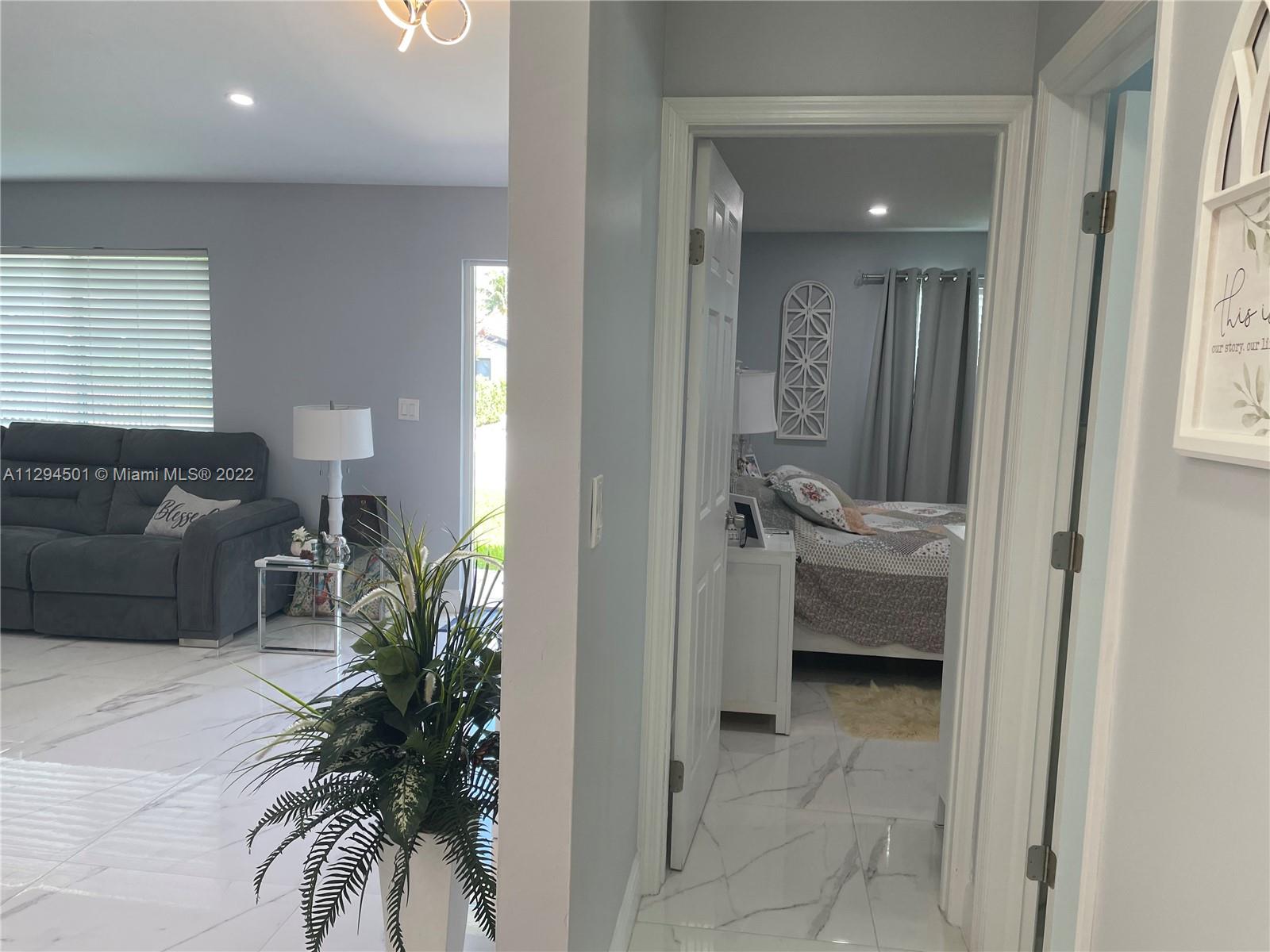 2222 Southwest 138th Avenue Miami, FL 33175 - Photo 13 of 27 a living room with furniture and a potted plant