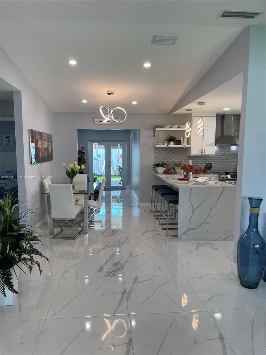 2222 Southwest 138th Avenue Miami, FL 33175 - Photo 2 of 27 a kitchen with stainless steel appliances granite countertop a sink and cabinets