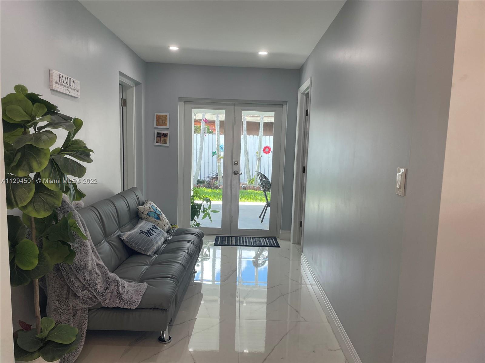 2222 Southwest 138th Avenue Miami, FL 33175 - Photo 22 of 27 a living room with furniture and a window