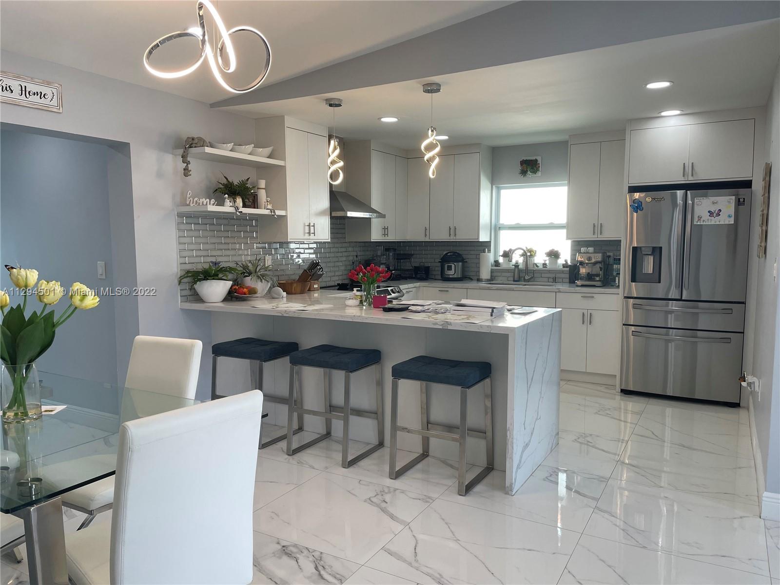 2222 Southwest 138th Avenue Miami, FL 33175 - Photo 23 of 27 a kitchen with granite countertop a sink stainless steel appliances and cabinets