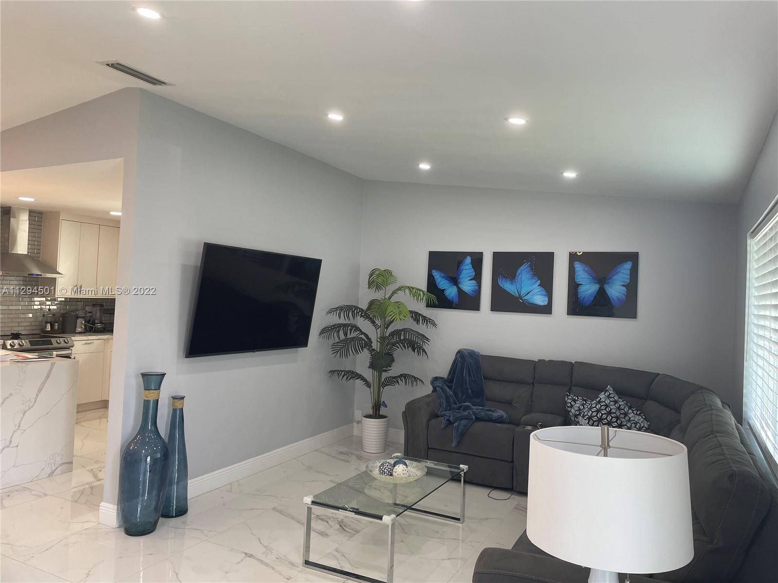 2222 Southwest 138th Avenue Miami, FL 33175 - Photo 25 of 27 a living room with furniture and a flat screen tv