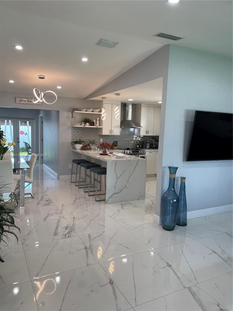 2222 Southwest 138th Avenue Miami, FL 33175 - Photo 3 of 27 a kitchen with stainless steel appliances granite countertop a stove and a sink