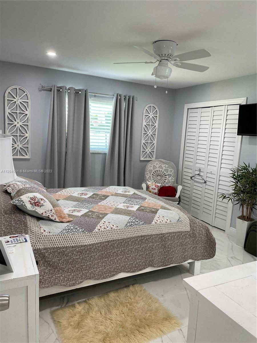 2222 Southwest 138th Avenue Miami, FL 33175 - Photo 5 of 27 a bedroom with a bed and a couch