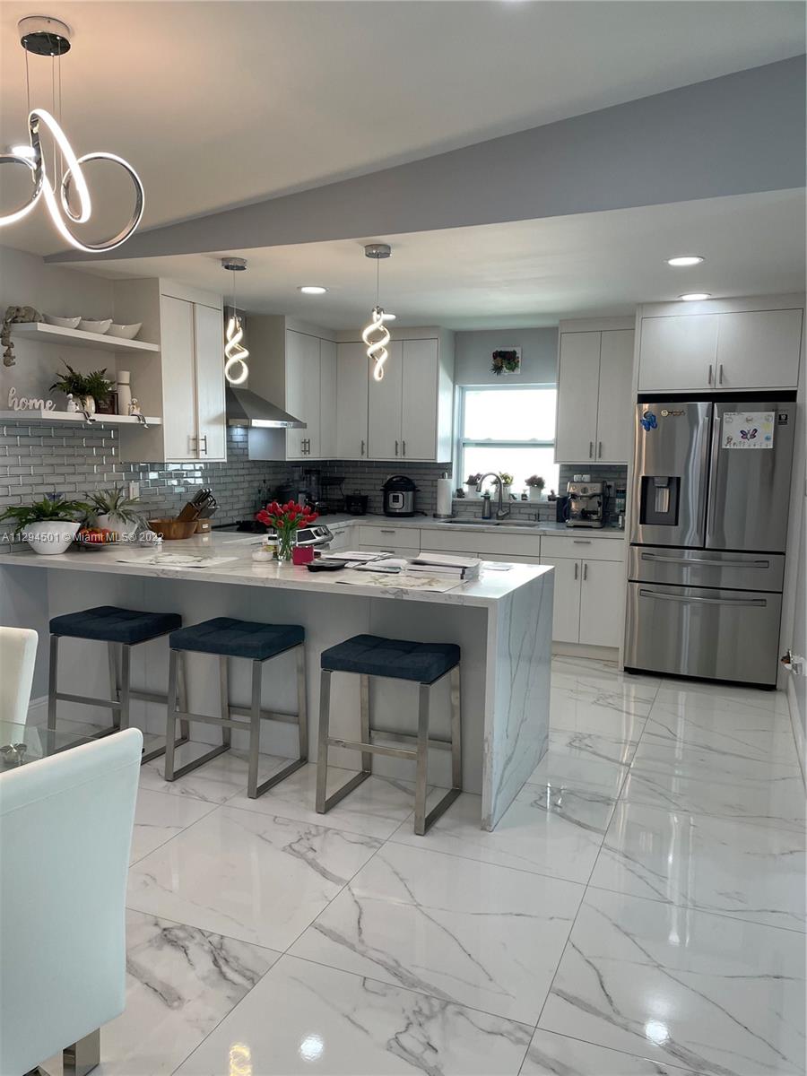 2222 Southwest 138th Avenue Miami, FL 33175 - Photo 7 of 27 a kitchen with counter top space appliances and cabinets