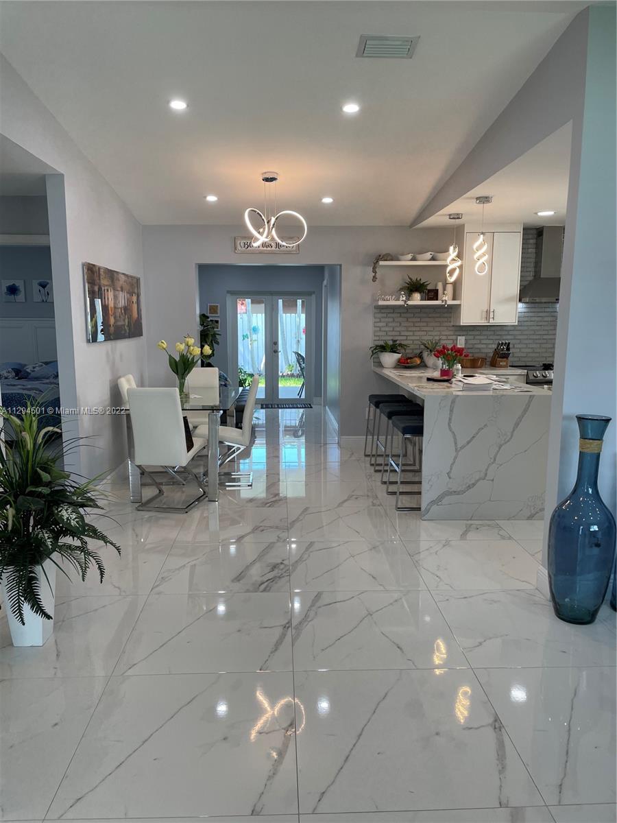 2222 Southwest 138th Avenue Miami, FL 33175 - Photo 10 of 27 a living room with furniture a large window and potted plants