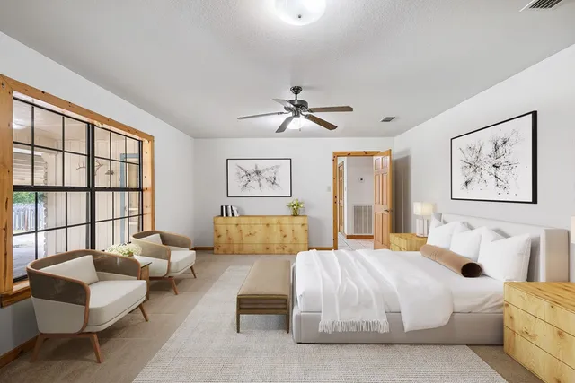 a spacious bedroom with a bed and a couch